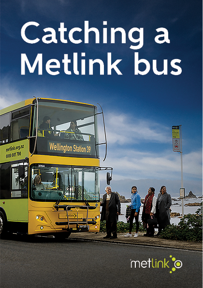Image shows the cover of the guide. It is called "Catching a MetLink bus". The image shows a double decker MetLink bus at a coastal bus stop. The bus number is 39 and it is going to Wellington Station. Four adults are waiting by the bus stop sign to get on the bus. They are looking up the road. Two passengers are visisble in the top seats at the front of the bus.