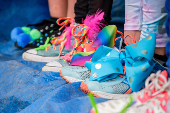 A row of children's shoes decorated in bright colours