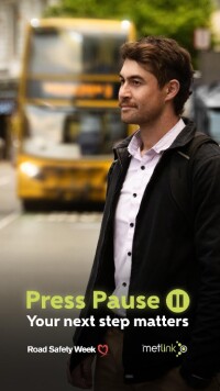 MetLink branded Press Pause poster, with a man in foreground waiting on bus in background. Tagline is Your next step matters